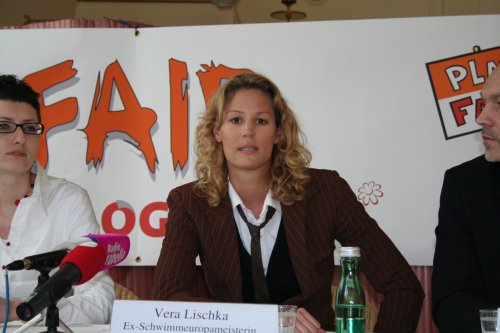 APRIL 1 - VIENNA: Former European swimming champion Vera Lischka speaking out in support of Catch the Flame at the launch in Austria. Lischka held up her adidas shoe during the press conference to draw attention to the low wages paid to the workers who actually made it.